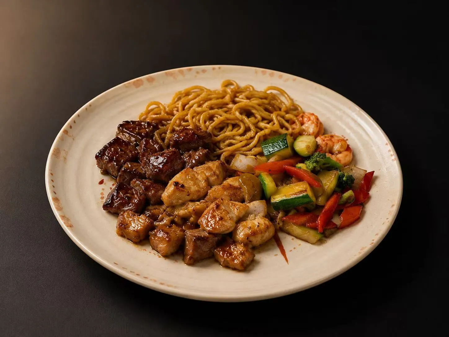 Hibachi plate with steak, chicken, shrimp, noodles and mixed stir-fried vegetables